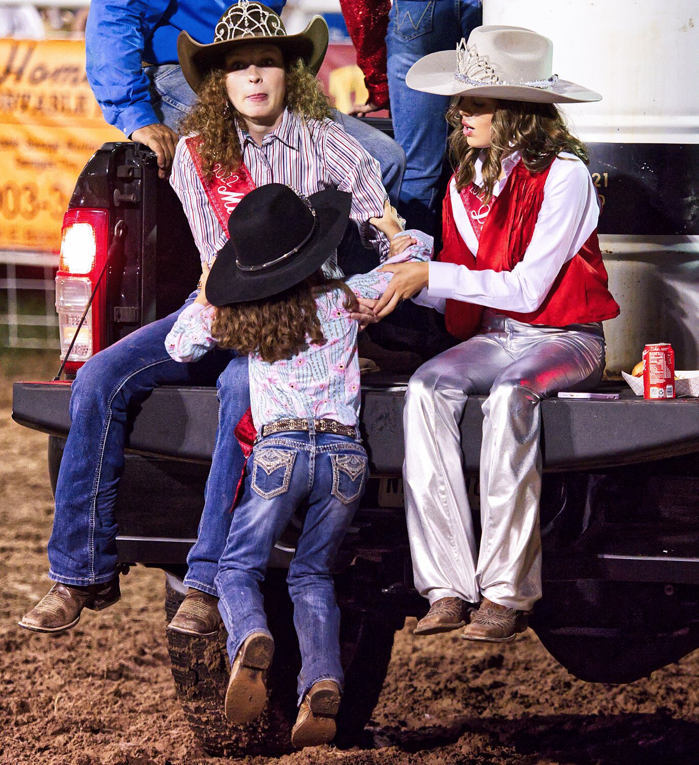 2022 royalty helped make adjustments to the racing barrels in between the senior and junior divisions. Miss MFDR Mikayla Mitchell and Jr. Miss MFDR Kaetynn Santellan help Little Miss MFDR Layla Carrell back into the pickup bed. [see more sights and MFDR 2023 rodeo action]